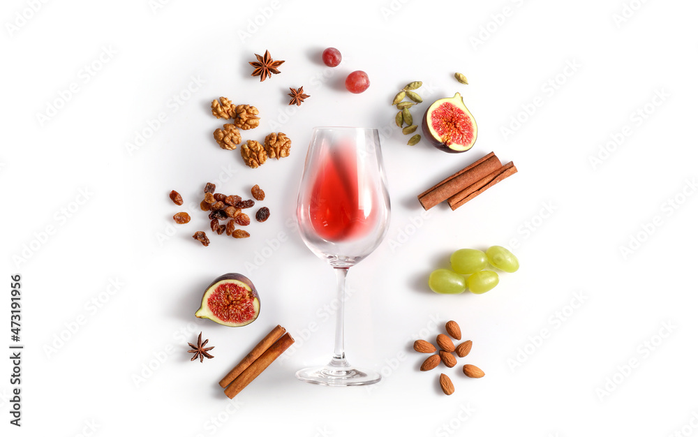 Red wine and possibble ingredients of grape, cinnamon, figs isoalted on white background Red wine and possibble ingredients of grape, cinnamon, figs isoalted on white background