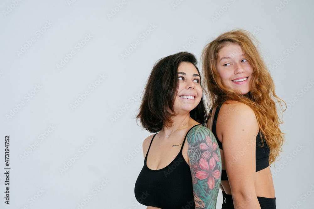 Two young women posing over white background. Two young women posing over white background.
