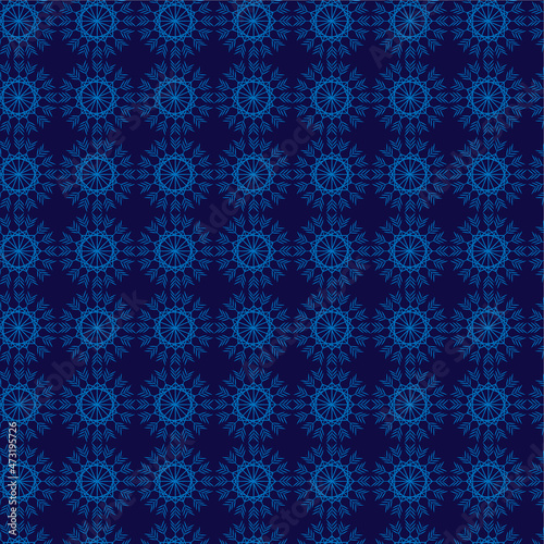 Seamless pattern with delicate geometric shapes, like snowflakes on a dark blue background. Vector graphics