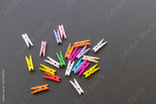 Small colorful pegs on a black background