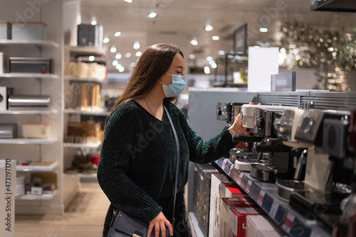 Female customer choosing coffee machine