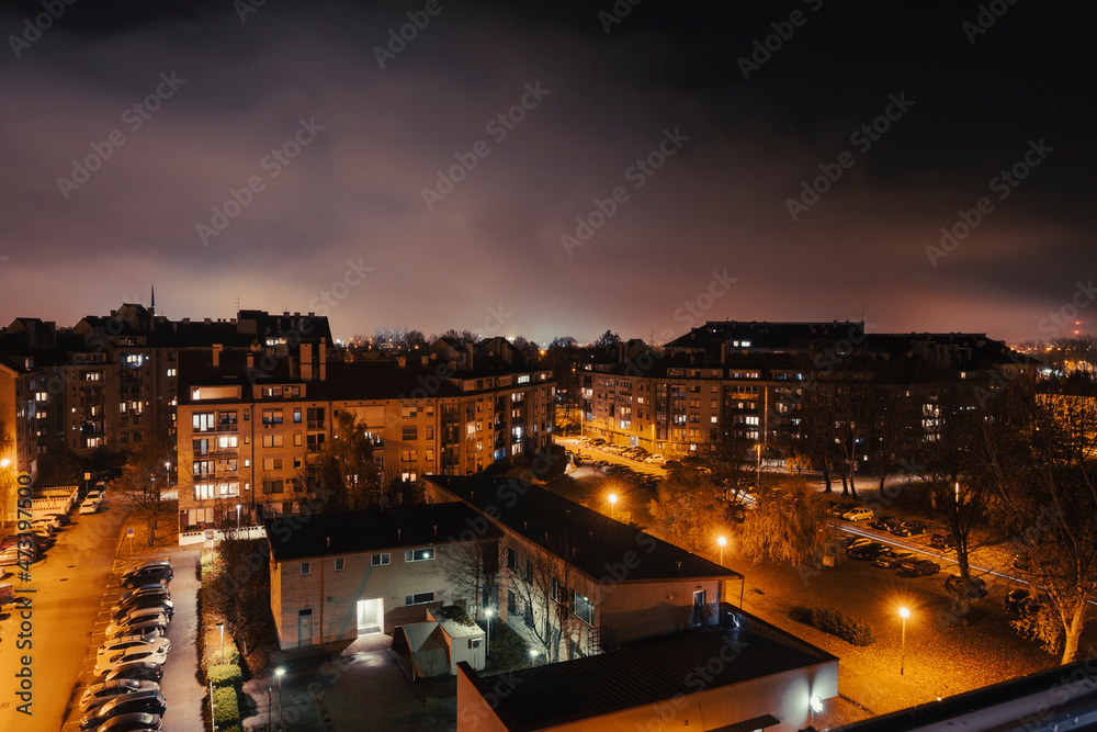 Dense clouds coverng Zagreb city, reflecting the urban lights during the night and creating wonderful, colorful scene