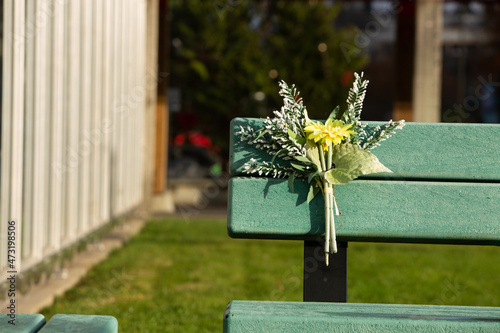 Bouquet of flowers placed on a park bench in Port Alberni photo