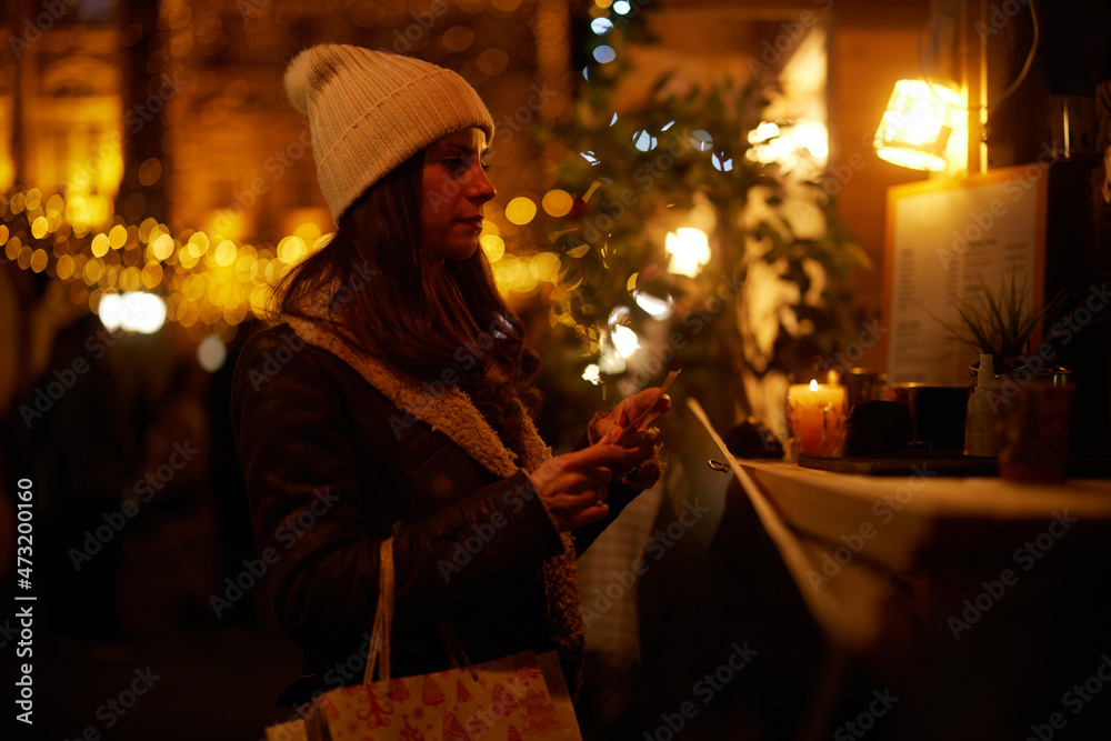 Happy woman at the Christmas market at night