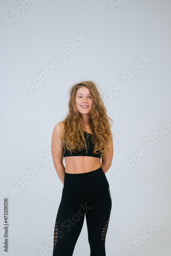An ordinary young woman on a white background. Bodypositive concept. © teksomolika