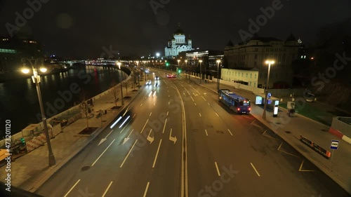 timelapse of traffic at night on the Prechistenskaya embankment and the Cathedral of Christ the Saviour in Moscow, Russia photo
