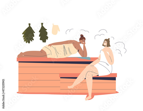 Two women relax in sauna or banya wearing towels and lying on wooden benches enjoy hot water stream