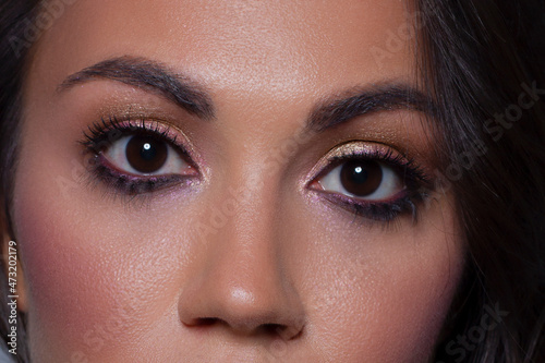 Elegance close-up female eye with light pink eyeshadow. Macro shot of part of the face of a beautiful woman. Wellness, cosmetics and makeup. smooth beautiful eyebrows and eyelashes