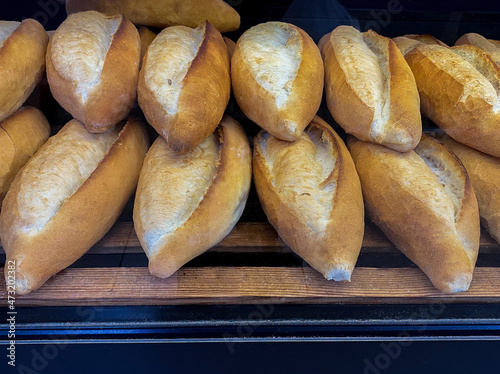 Loaves of bread lined up on the counter