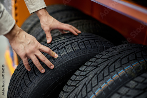 close-up of a man's hand with car tires