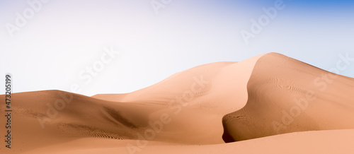 Pale yellow dunes and dark blue sky. Desert dunes landscape with contrast skies. Minimal abstract background. 3d rendering