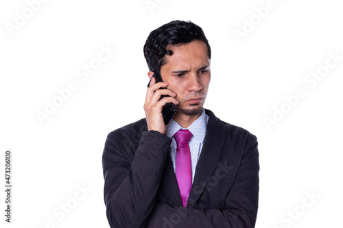 Elegant man talking on the phone with serious expression, isolated on white background.