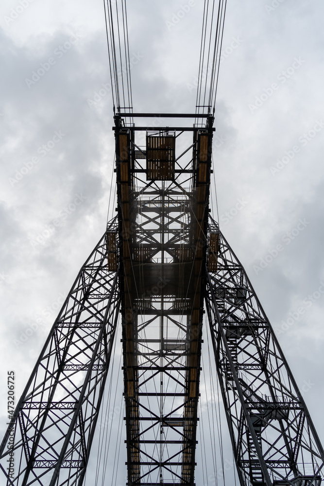 Transporter Bridge over the Charente river under a cloudy sky. National monument. Rochefort sur mer. France Transporter Bridge over the Charente river under a cloudy sky. National monument. Rochefort sur mer. France
