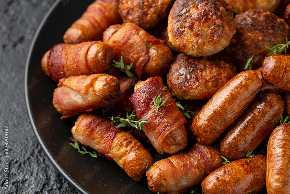 Pigs in Blankets, cocktail sausages and meatballs on plate. Party food Pigs in Blankets, cocktail sausages and meatballs on plate. Party food