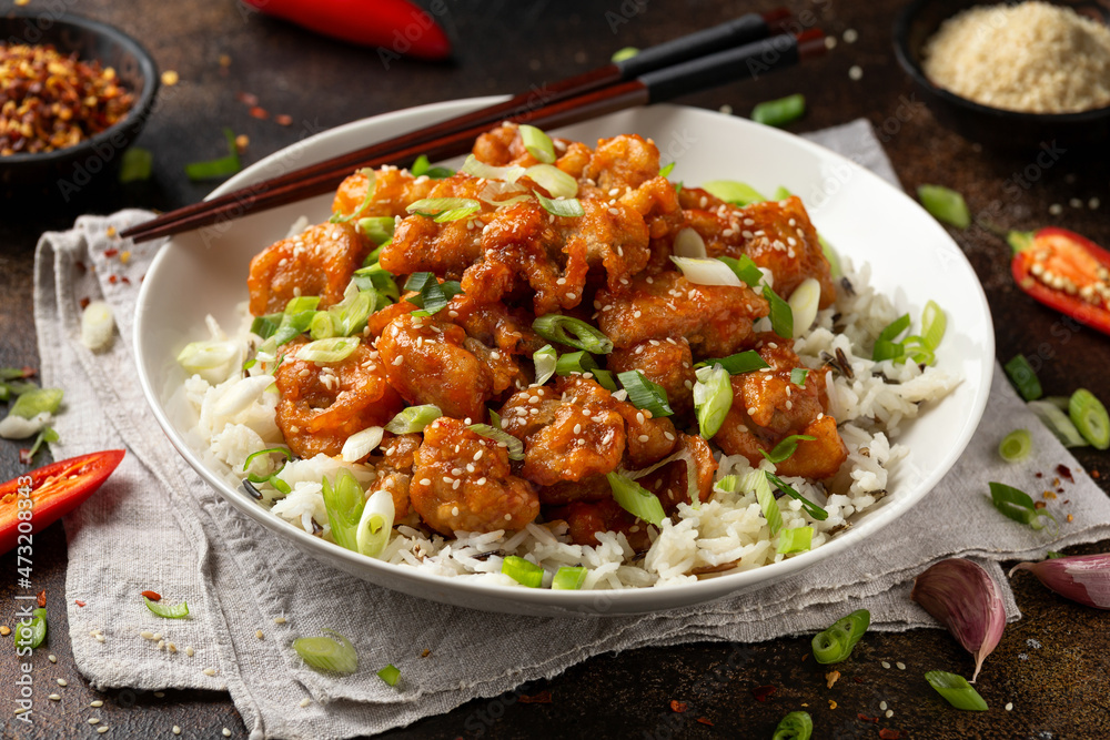 Asian crispy sweet sesame chicken with basmati, wild rice and spring onion. Asian crispy sweet sesame chicken with basmati, wild rice and spring onion.
