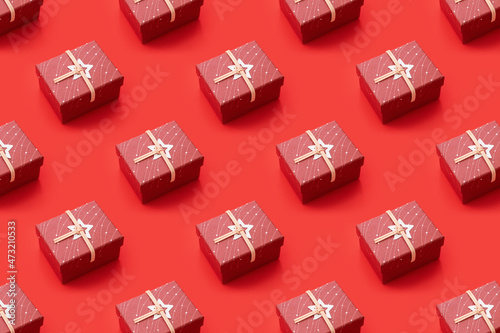 Trendy pattern made with gift box on bright red background. Minimal concept 