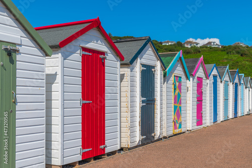 Colorful beach houses. Row of multicolored beach huts against blue sky.