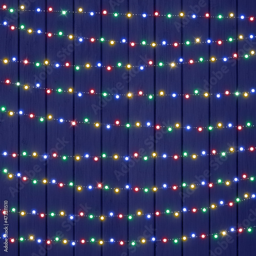 Fotografie Beautiful Colorful String Lights on Blue Wood Texture