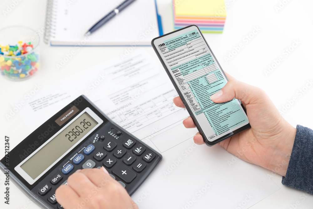 Accountant working with US tax forms Accountant working with US tax forms