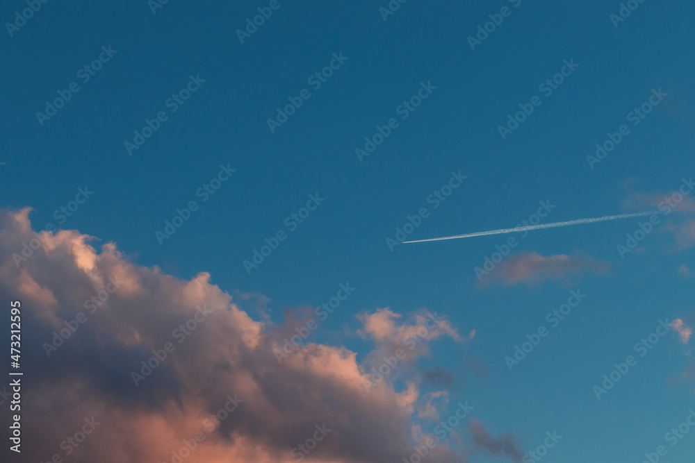 Sky with clouds and a wake of an airplane Sky with clouds and a wake of an airplane