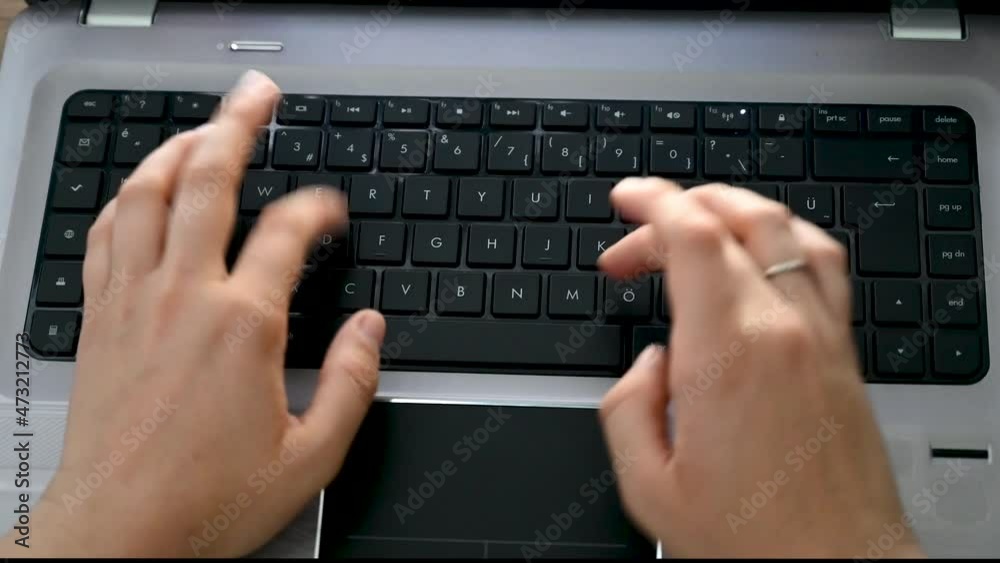 Girl typing on laptop. Woman using laptop computer at desk in office. Hands of business woman working on laptop, close up. Girl typing on laptop. Woman using laptop computer at desk in office. Hands of business woman working on laptop, close up.