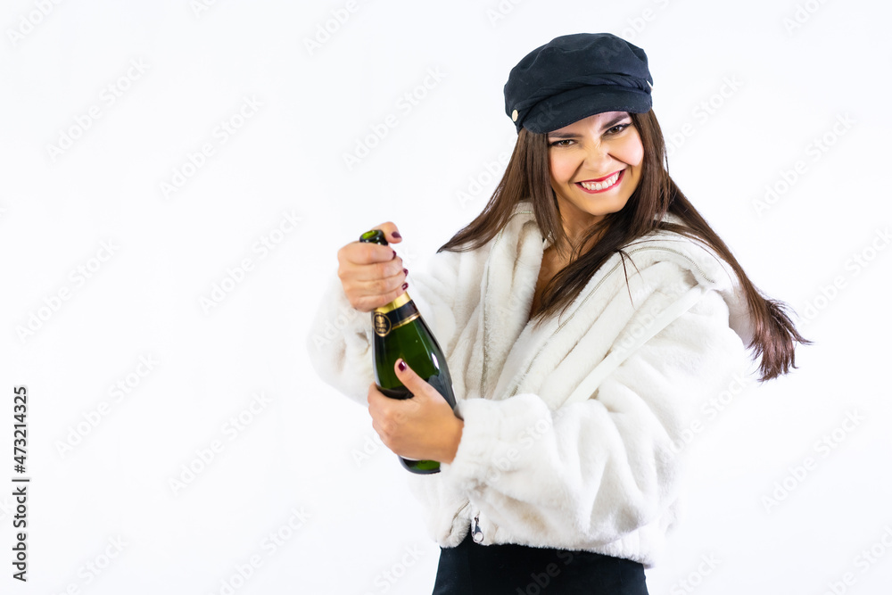 Young Latin girl celebrating New Years Eve on a white background. Opening a bottle of champagne Young Latin girl celebrating New Years Eve on a white background. Opening a bottle of champagne