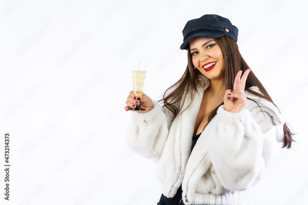 Young Latin girl with black hat celebrating New Years Eve on a white background. With a glass of champagne very smiling Young Latin girl with black hat celebrating New Years Eve on a white background. With a glass of champagne very smiling