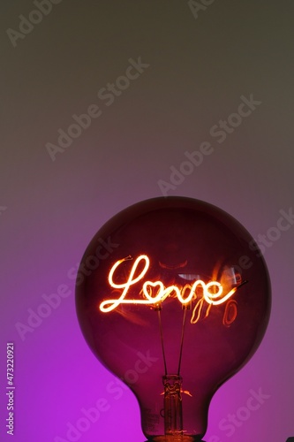 Valentine's Day. Love light bulb.purple Light bulb with the inscription love on a purple background. Love and relationship symbol.Love concept. 