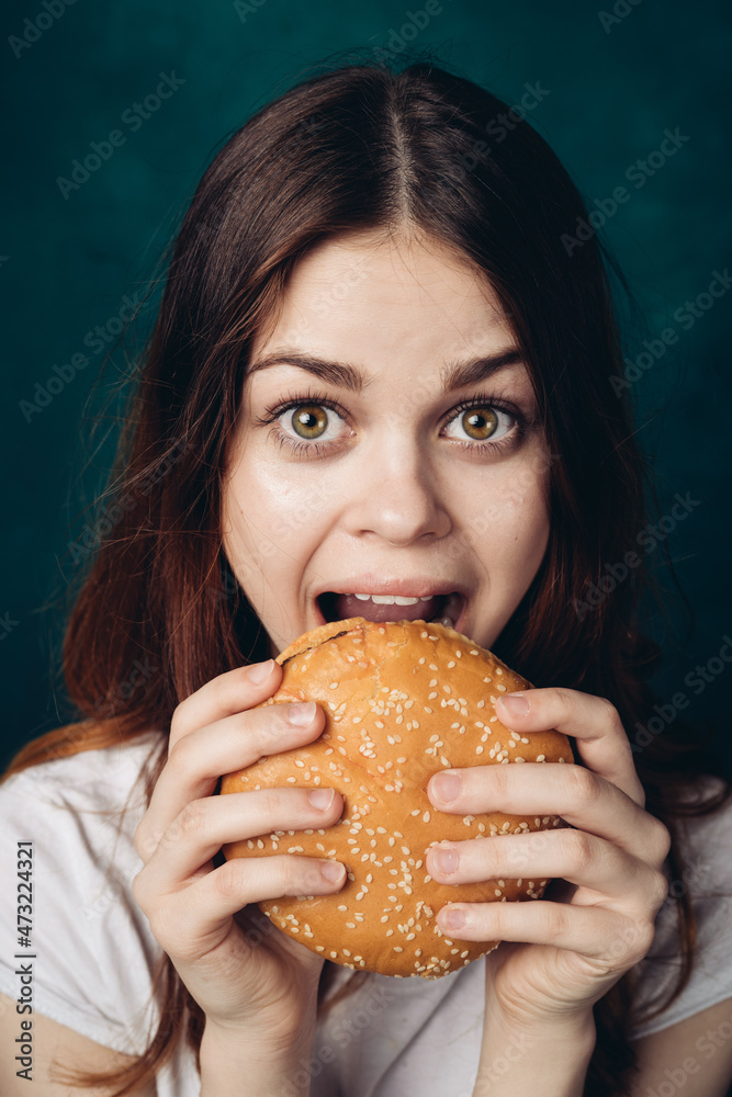 cheerful woman eating hamburger snack close-up lifestyle