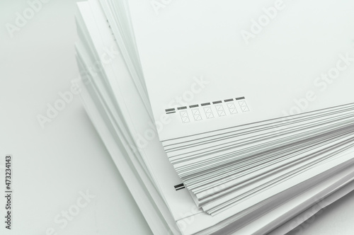 A stack of large white postal envelopes. Packaging for letters and documents. Postal supplies. Selective focus