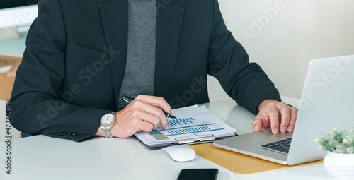 Fototapeta Naklejka Na Ścianę i Meble -  businessman working at office with document on his desk, doing planning analyzing the financial report, business plan investment, finance analysis concept.
