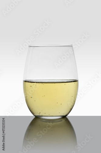 crystal glass with white wine and white background