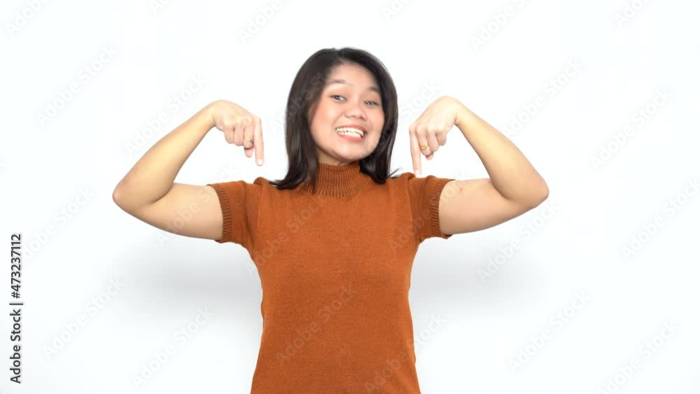 Pointing Down of Beautiful Asian Woman Wearing Orange T-Shirt Isolated On White Background Pointing Down of Beautiful Asian Woman Wearing Orange T-Shirt Isolated On White Background