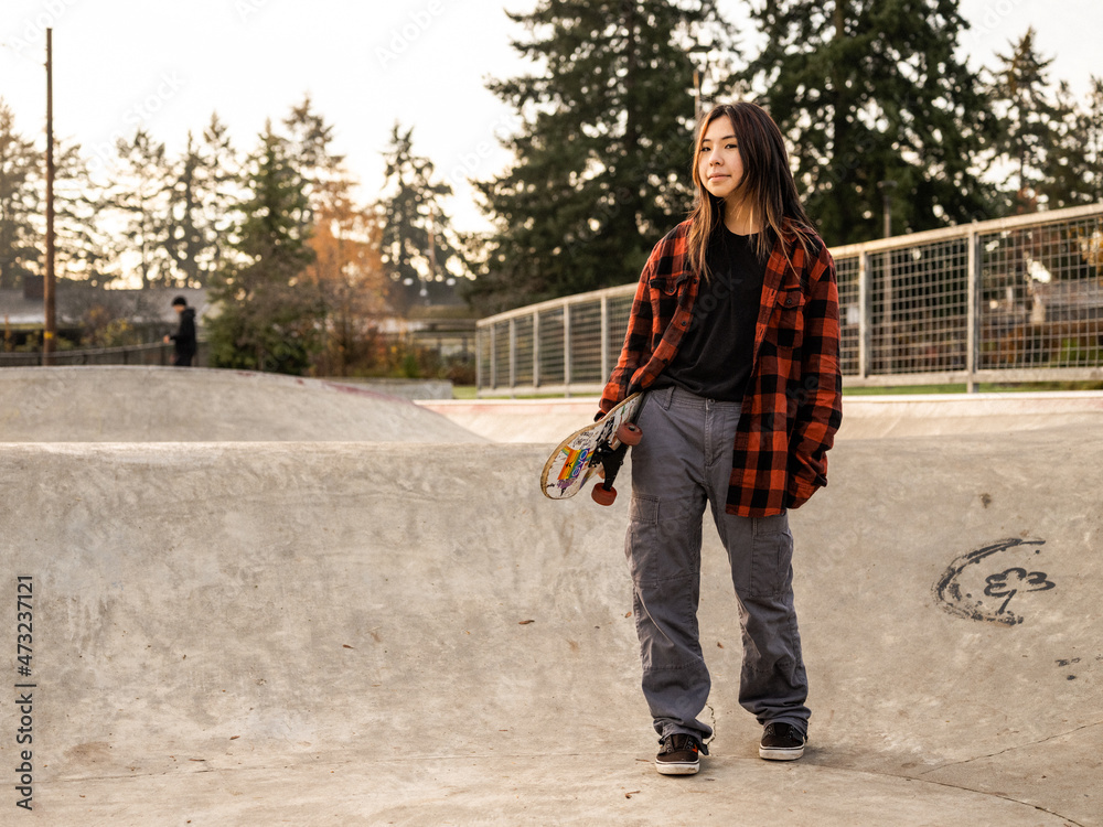 Young Indigenous nonbinary skater outdoors Stock Photo Adobe Stock