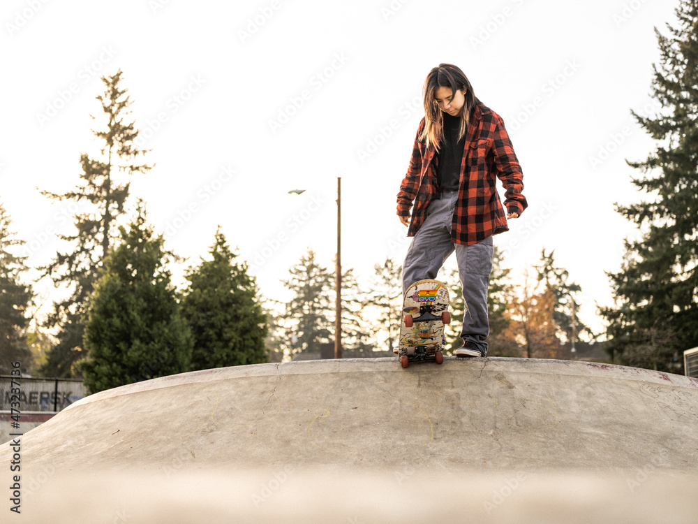 Young Indigenous nonbinary skater outdoors Stock Photo Adobe Stock