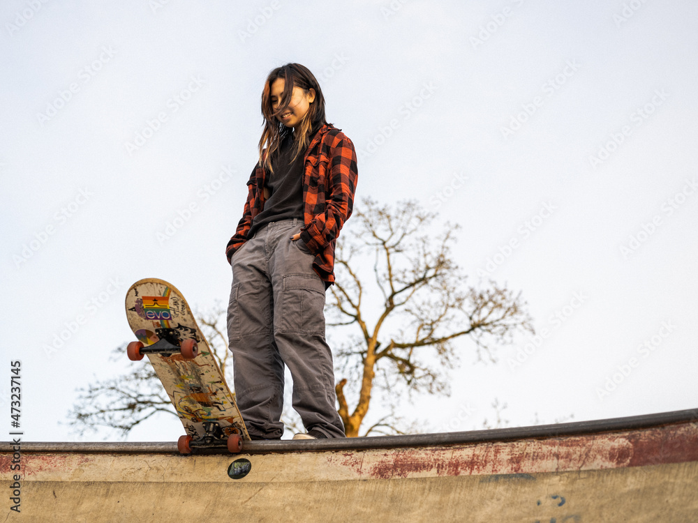 Young Indigenous nonbinary skater outdoors Stock Photo Adobe Stock