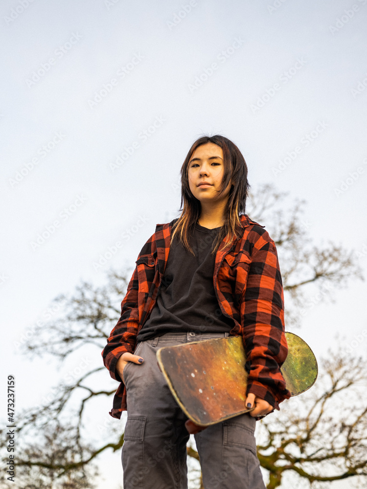 Young Indigenous nonbinary skater outdoors Stock Photo Adobe Stock