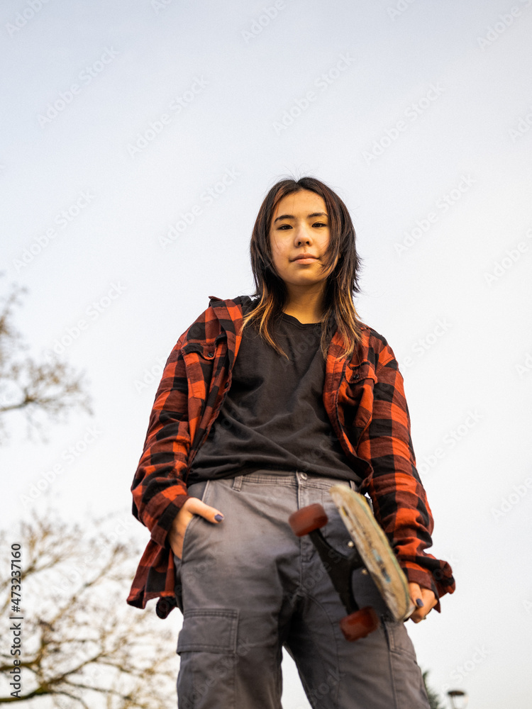 Young Indigenous nonbinary skater outdoors Stock Photo Adobe Stock