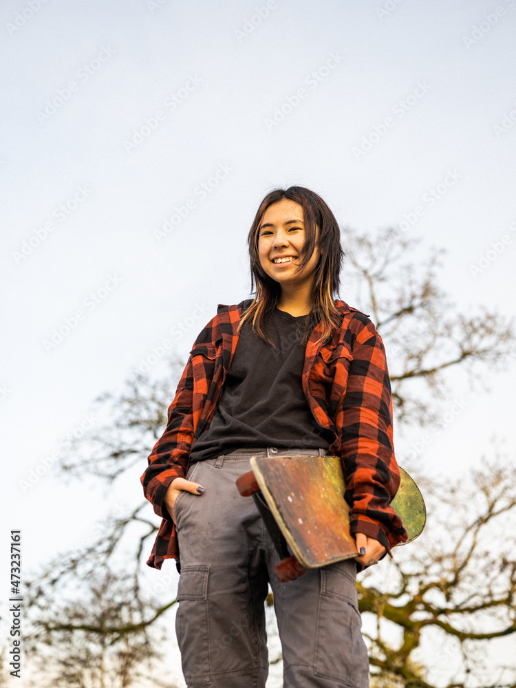 Young Indigenous nonbinary skater outdoors Stock Photo Adobe Stock