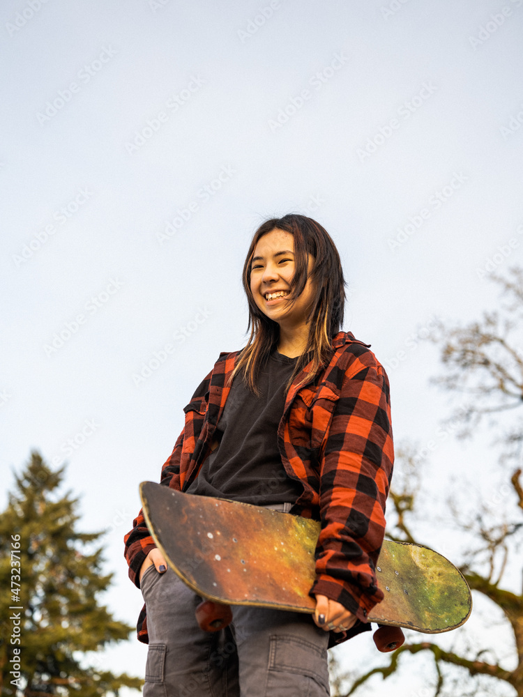 Young Indigenous nonbinary skater outdoors Stock Photo Adobe Stock