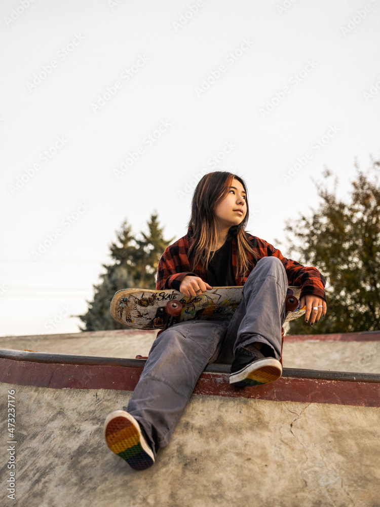 Young Indigenous nonbinary skater outdoors Stock Photo Adobe Stock