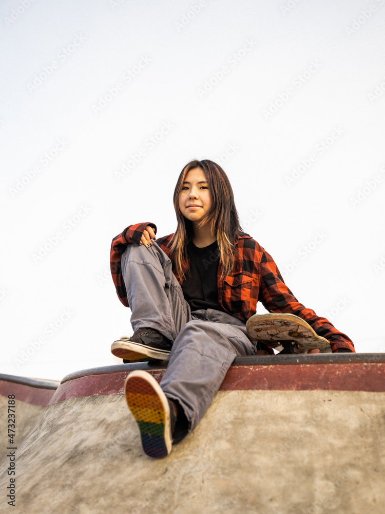 Young Indigenous nonbinary skater outdoors Stock Photo Adobe Stock