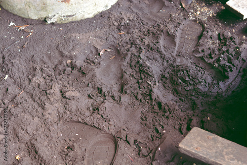 Imprint of the shoe on brown sand with copy space. photo