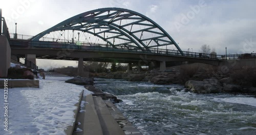 Speer Boulevard Bridge Over South Platte River In Denver, Colorado With Snowy Riverbank In Winter. panning right photo