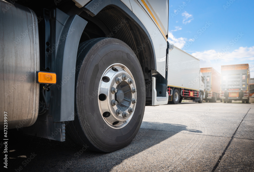 Close-up, Front of Truck Wheels a Parking lot. Shipping Cargo Trucks. Industry Freight Truck Logistics Cargo Transport Concept.	