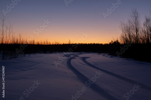 Travel at dawn across the frosty expanses of Siberia. Dawn over a winter landscape in the Khanty-Mansiysk Autonomous Okrug in Russia.