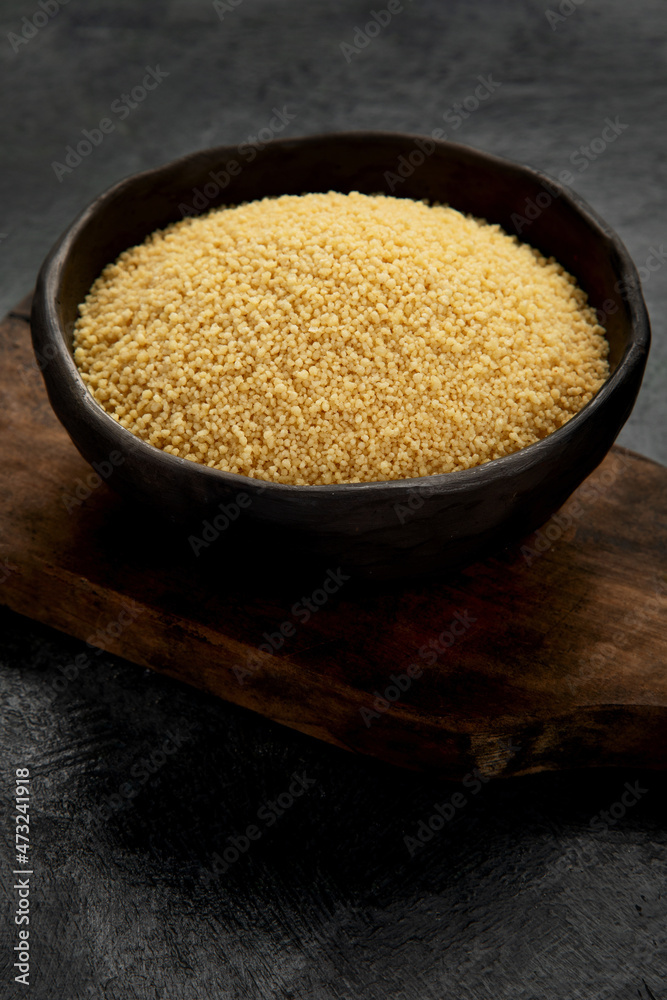 Couscous on dark background. Couscous on dark background.
