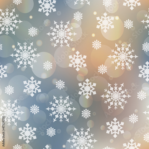 Festive seamless winter bokeh background in soft blue and golden pastel colors with white snowflakes