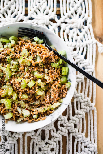 vegan instant noodles with ginger and soy sauce topped with celeri corainder seeds and chilli flakes, healthy plant-based food photo