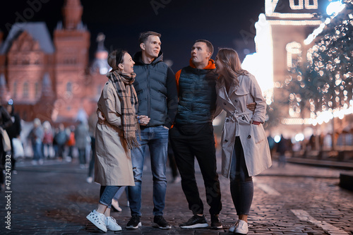 red square evening winter, a group of friends for a walk new year christmas moscow russia